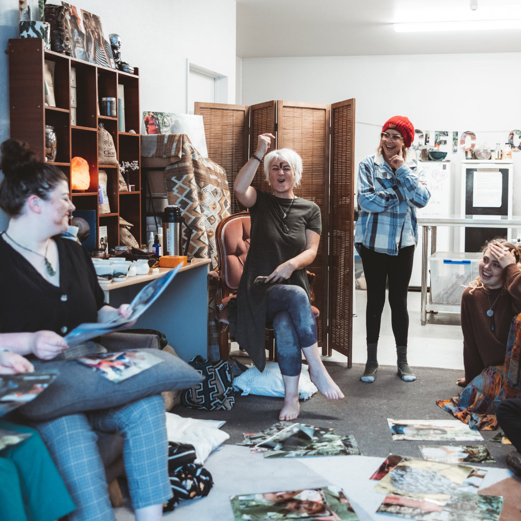 Group of people in a room with photos on the floor