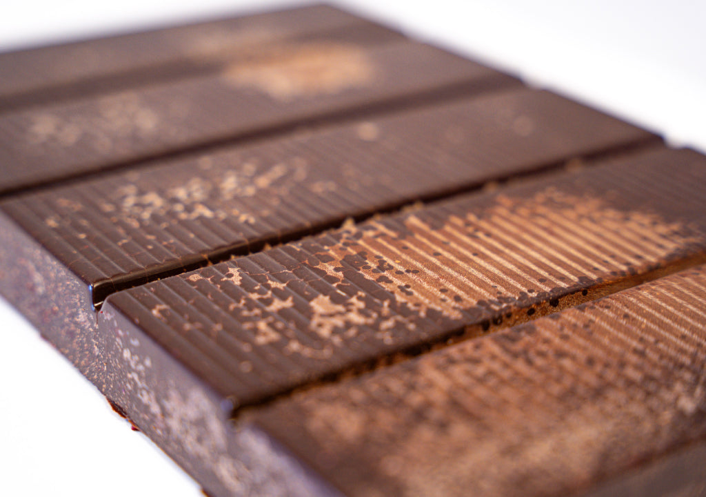 Close-up of pure cacao paste with visible texture and branding.