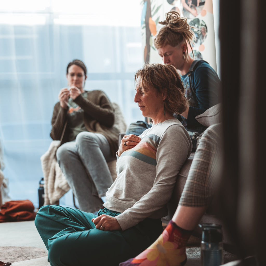 Group of people sitting together in a casual indoor setting