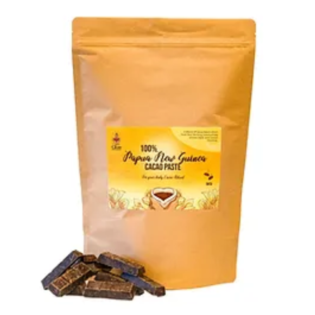 A package of 100% Pure PNG Cacao Paste with a small pile of cacao pieces in front of it.