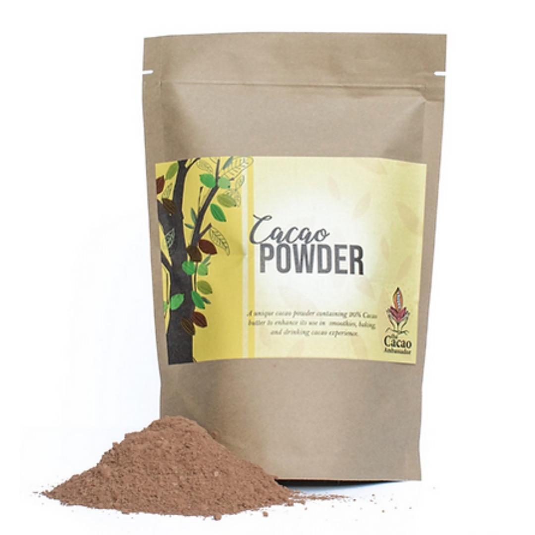 A package of PNG cacao powder with a small pile of cocoa powder in front of it, against a white background.